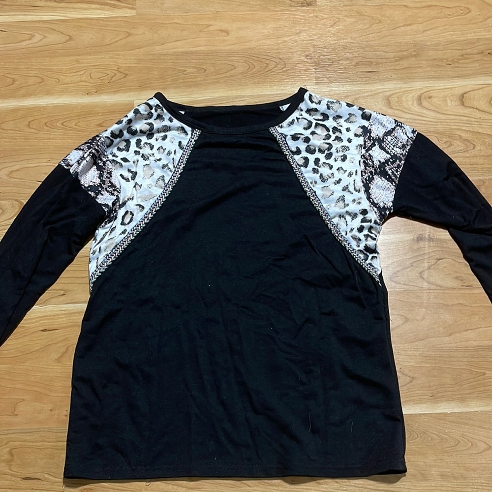 Black and fancy addition to arms shirt